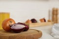 Fresh cut and whole onions on wooden board in modern kitchen, closeup. Space for text Royalty Free Stock Photo