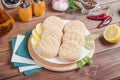 Fresh cutlets, semi-finished products for burgers from poultry meat on a white plate on a dark wooden background