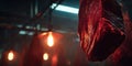 Raw meat hanging in a dimly lit meat processing area showcasing fresh cuts under warm lights Royalty Free Stock Photo