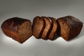 Fresh cutted bread baked homemade artisan sourdough rye on gray background close-up. Royalty Free Stock Photo