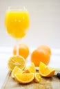 Fresh cutted orange and juice on wooden plank Royalty Free Stock Photo