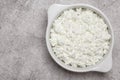 Fresh dairy farm product cottage cheese in ceramic bowl on a concrete background on table close-up top view. Healthy Royalty Free Stock Photo