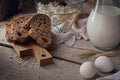 Fresh dairy products. Milk, cottage cheese, sour cream, multigrain homemade bread, fresh eggs and wheat on wooden background. Royalty Free Stock Photo