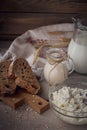 Fresh dairy products. Milk, cottage cheese, sour cream, multigrain homemade bread and wheat on rustic wooden background. Royalty Free Stock Photo