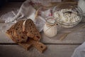 Fresh dairy products. Milk, cottage cheese, sour cream, multigrain homemade bread and wheat on rustic wooden background. Royalty Free Stock Photo