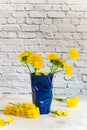 Fresh dandelions in a blue cup