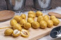 Fresh date palm fruit on a wooden plate, Sweet yellow date palm fruit. Royalty Free Stock Photo