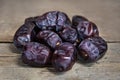 Fresh dates on wooden table, sort mazafati, sweet vegan superfruit