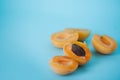 Fresh delicious apricots on a blue background. Royalty Free Stock Photo