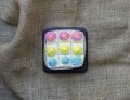 Fresh and delicious bento mini vanilla cupcakes with whipping cream pastel colors. on brown fabric background. Top view
