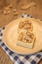 Fresh delicious caramel nut tart dessert on wooden plate Royalty Free Stock Photo