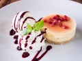 Fresh delicious cheesecake with vanilla ice-cream, berries sauce Royalty Free Stock Photo