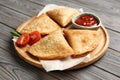 Fresh delicious crispy samosas served on wooden table, closeup Royalty Free Stock Photo
