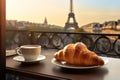 Fresh delicious french croissant and coffee, romantic parisian morning with Eiffel Tower blur view