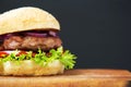 Fresh and delicious home made burger on wooden board with copy space. Royalty Free Stock Photo