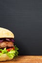 Fresh and delicious home made burger on wooden board with copy space. Royalty Free Stock Photo