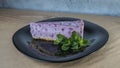 Fresh delicious piece of blueberries cake with and mint on black plate. Slice of blueberry pie with mint.