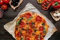 Fresh delicious pizza with pizza ingredients on the wooden table, top view Royalty Free Stock Photo