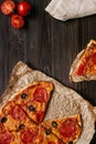 Fresh delicious pizza with pizza ingredients on the wooden table, top view Royalty Free Stock Photo