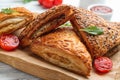 Fresh delicious puff pastry served on wooden table, closeup