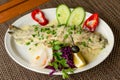 Fresh delicious trout in white creamy sauce, with vegetables on