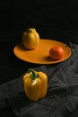 fresh and delicious, yellow peppers, quince and tangerine on black background Royalty Free Stock Photo