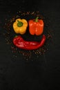 fresh and delicious, yellow, red and orange peppers on black background Royalty Free Stock Photo