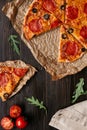 Fresh delisious pizza with pizza ingredients on the wooden table, top view