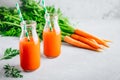 Fresh detox carrot juice in glass bottles on a gray stone background Royalty Free Stock Photo