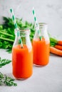 Fresh detox carrot juice in glass bottles on a gray stone background Royalty Free Stock Photo