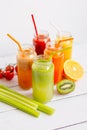 Fresh detox juices in glass bottles on white background