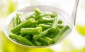 Fresh diced green runner beans in a kitchen ladle