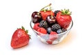 Fresh different berries in glass bowl isolated on white. Royalty Free Stock Photo