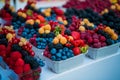 Fresh different berries in the plastic cup at Europe street berries and exotic fruits at market streetshop Royalty Free Stock Photo
