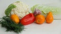 Fresh different vegetables yellow tomatoes, peppers, cauliflower, dill, garlic on a white background Royalty Free Stock Photo