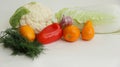 Fresh different vegetables yellow tomatoes, peppers, cauliflower, dill, garlic on a white background Royalty Free Stock Photo