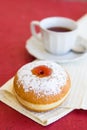 Fresh donut on a napkin with a cup of tea Royalty Free Stock Photo