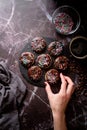 Fresh donuts with chocolate glaze and colorful sprinkles on dark background Royalty Free Stock Photo