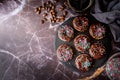 Fresh donuts with chocolate glaze and colorful sprinkles on dark background Royalty Free Stock Photo