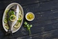 Fresh Dorado fish with lemon, lime and parsley on an oval dish Royalty Free Stock Photo