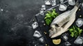 Fresh Dorado with lemon and marinade on a black cutting board with pieces of ice