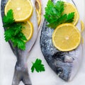 Fresh Dorado or Sea Bream with Lemon and Herbs, Raw Fish Ready to be Cooked, Top View Royalty Free Stock Photo