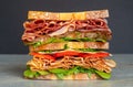 Fresh double layered sandwich with ham, lettuce, tomatoes, cheese on a toast bread, on black background Royalty Free Stock Photo