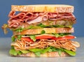 Fresh double layered sandwich with ham, lettuce, tomatoes, cheese on a toast bread. Food background. Close up Royalty Free Stock Photo