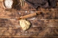 Fresh dough with rolling pin and flour on wooden table Royalty Free Stock Photo