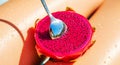 Fresh dragon fruit with spoon reflection and water drops under sunlight Royalty Free Stock Photo