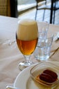 Fresh draught lager or IPA beer is glass served in indoor cafe close up, glass of beer Royalty Free Stock Photo