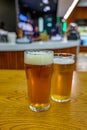 Fresh draught lager or IPA beer is glass served in indoor cafe close up, pint of beer Royalty Free Stock Photo