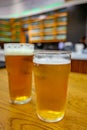 Fresh draught lager or IPA beer is glass served in indoor cafe close up, pint of beer Royalty Free Stock Photo