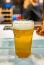 Fresh draught lager or IPA beer is glass served in indoor cafe close up, pint of beer Royalty Free Stock Photo